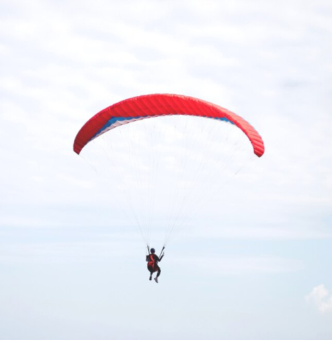 red-parachute-landing-windy-day_109549-487